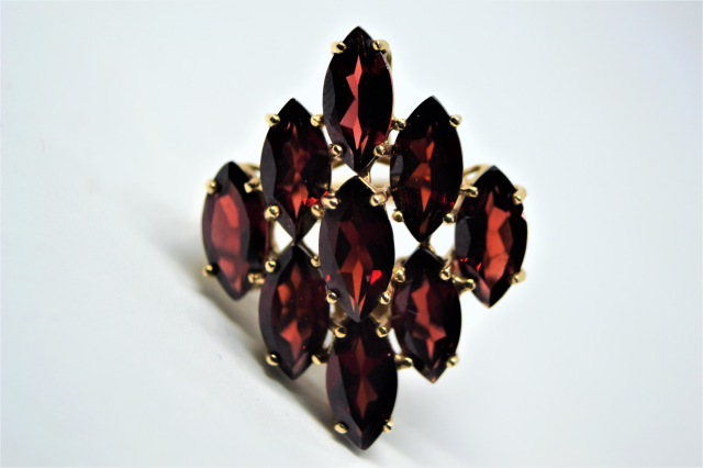 A 9ct Gold With Nine Navette Cut Garnet Ring.