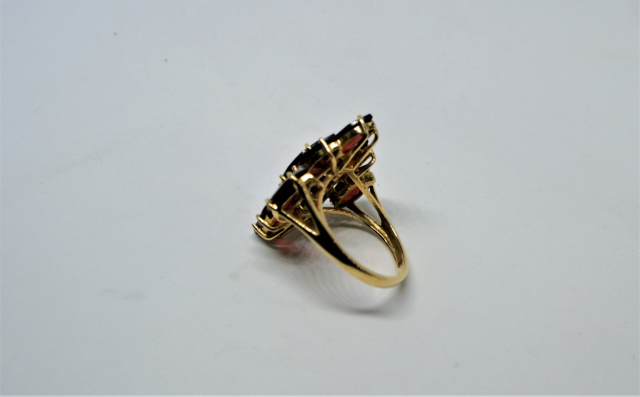 A 9ct Gold With Nine Navette Cut Garnet Ring.