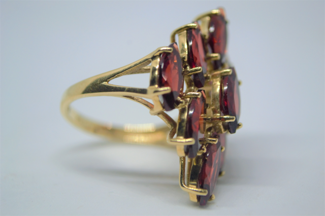 A 9ct Gold With Nine Navette Cut Garnet Ring.