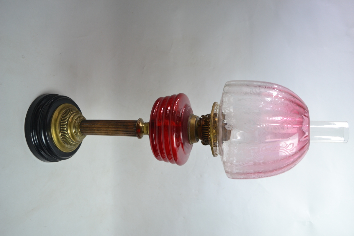 Discover our collection of exquisite Victorian cranberry glass oil lamps. This particular 27 piece boasts a unique wooden and brass stand. Shop now for antique treasures!