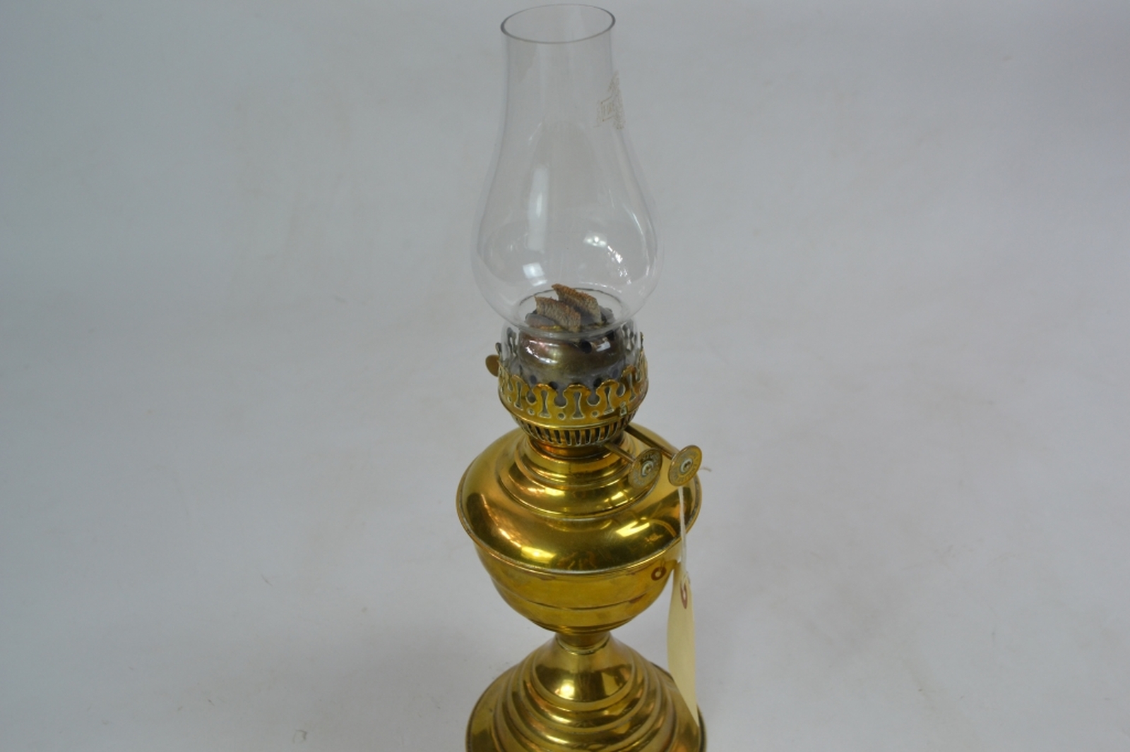 Brass oil lamp early 20th century of lobed baluster form with a typical plain glass chimney