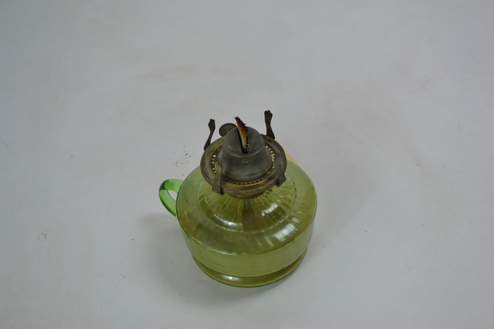 Early 20th century oil lamp with Incandescent green reservoir