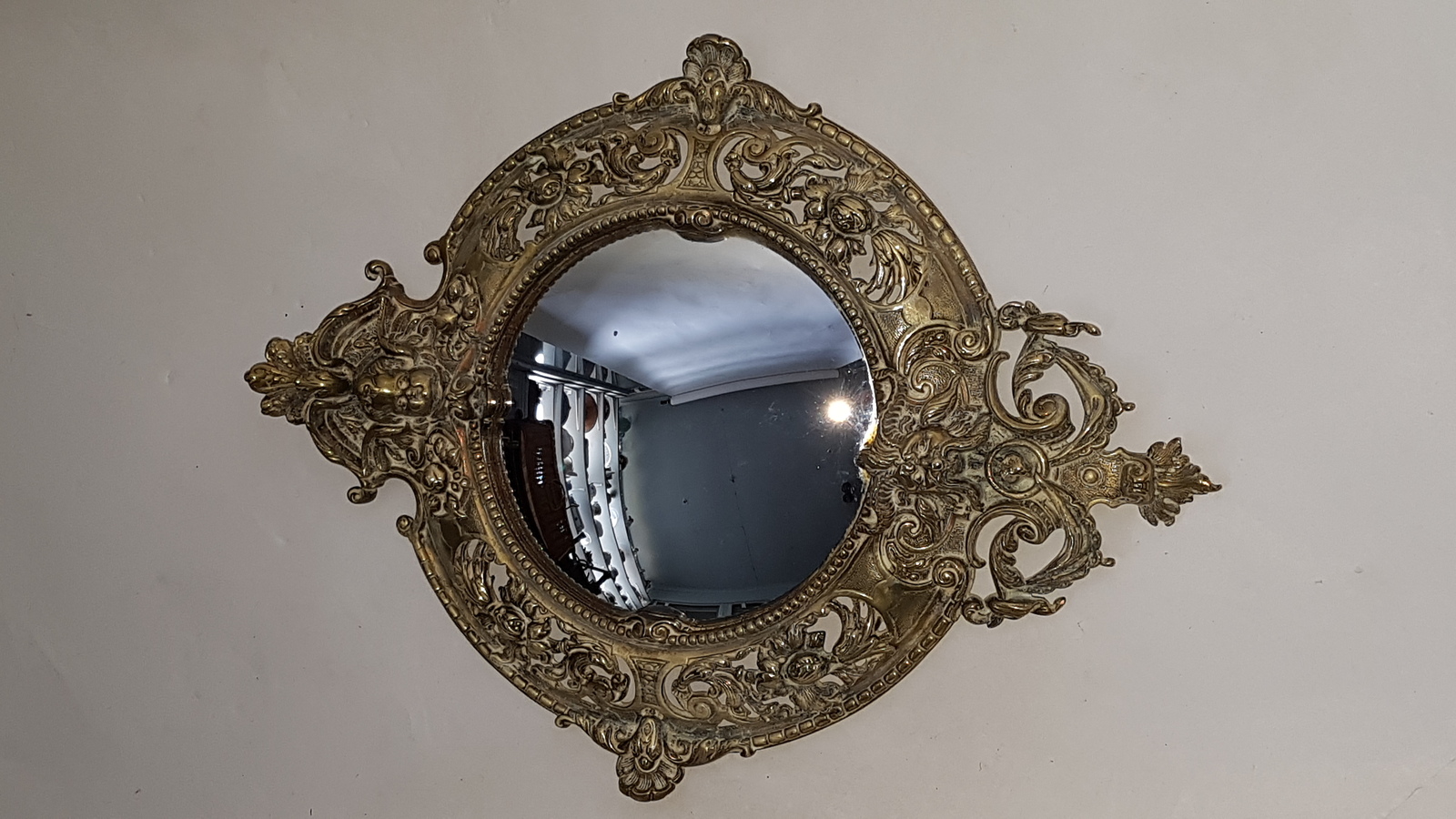 Discover our 19th-century cast brass convex wall mirror, embellished with intricate cherubs, satyr, and floral designs. Shop now for this unique 49cm x 37cm antique decor piece in excellent condition.