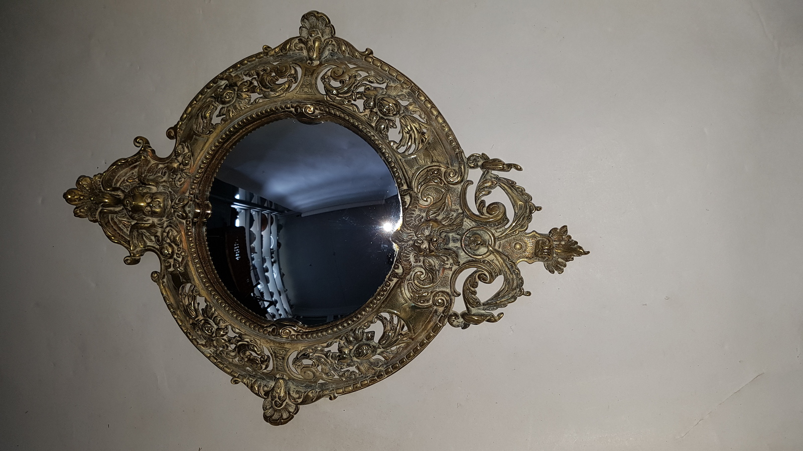 Discover our 19th-century cast brass convex wall mirror, embellished with intricate cherubs, satyr, and floral designs. Shop now for this unique 49cm x 37cm antique decor piece in excellent condition.