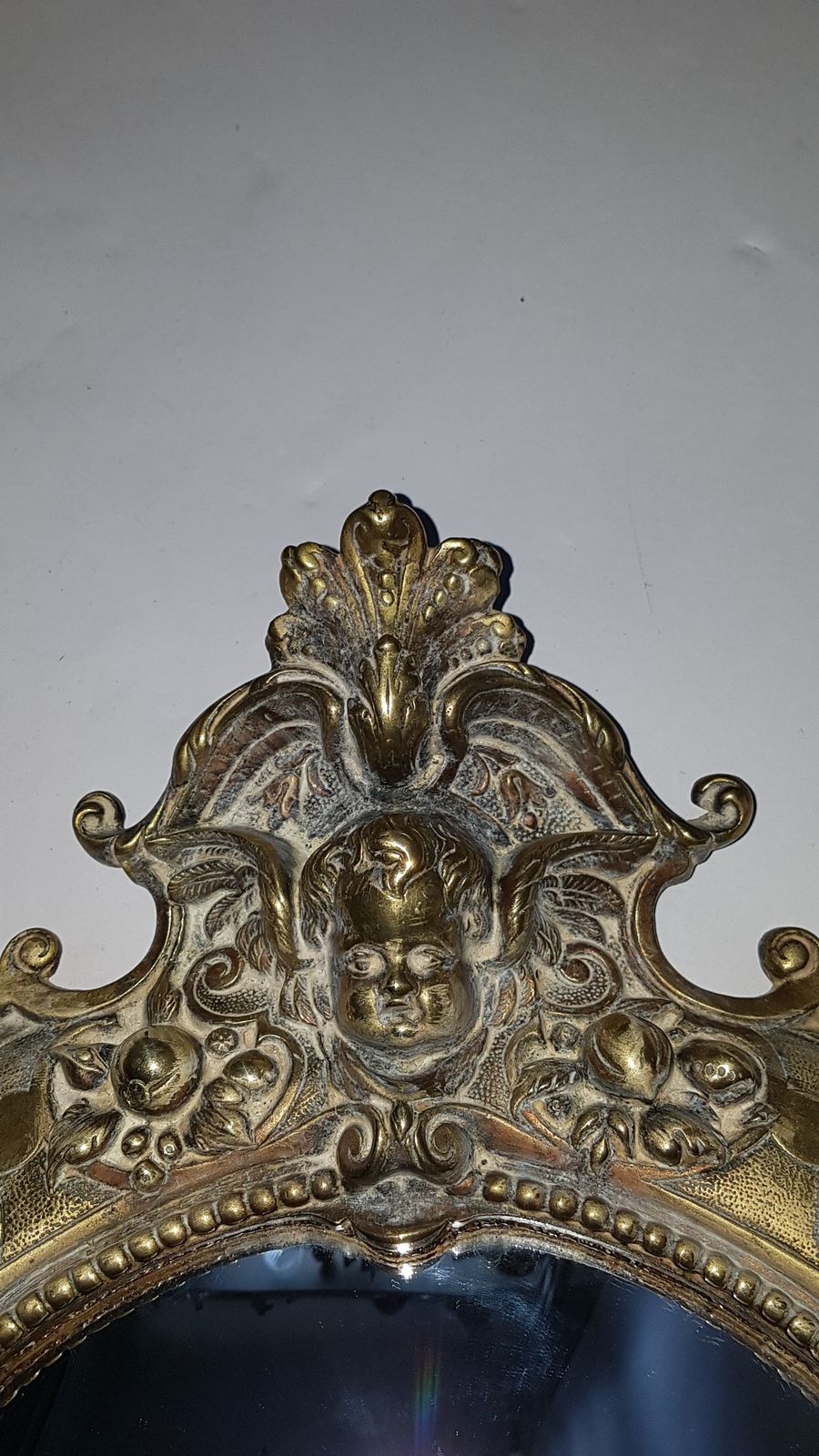 Discover our 19th-century cast brass convex wall mirror, embellished with intricate cherubs, satyr, and floral designs. Shop now for this unique 49cm x 37cm antique decor piece in excellent condition.