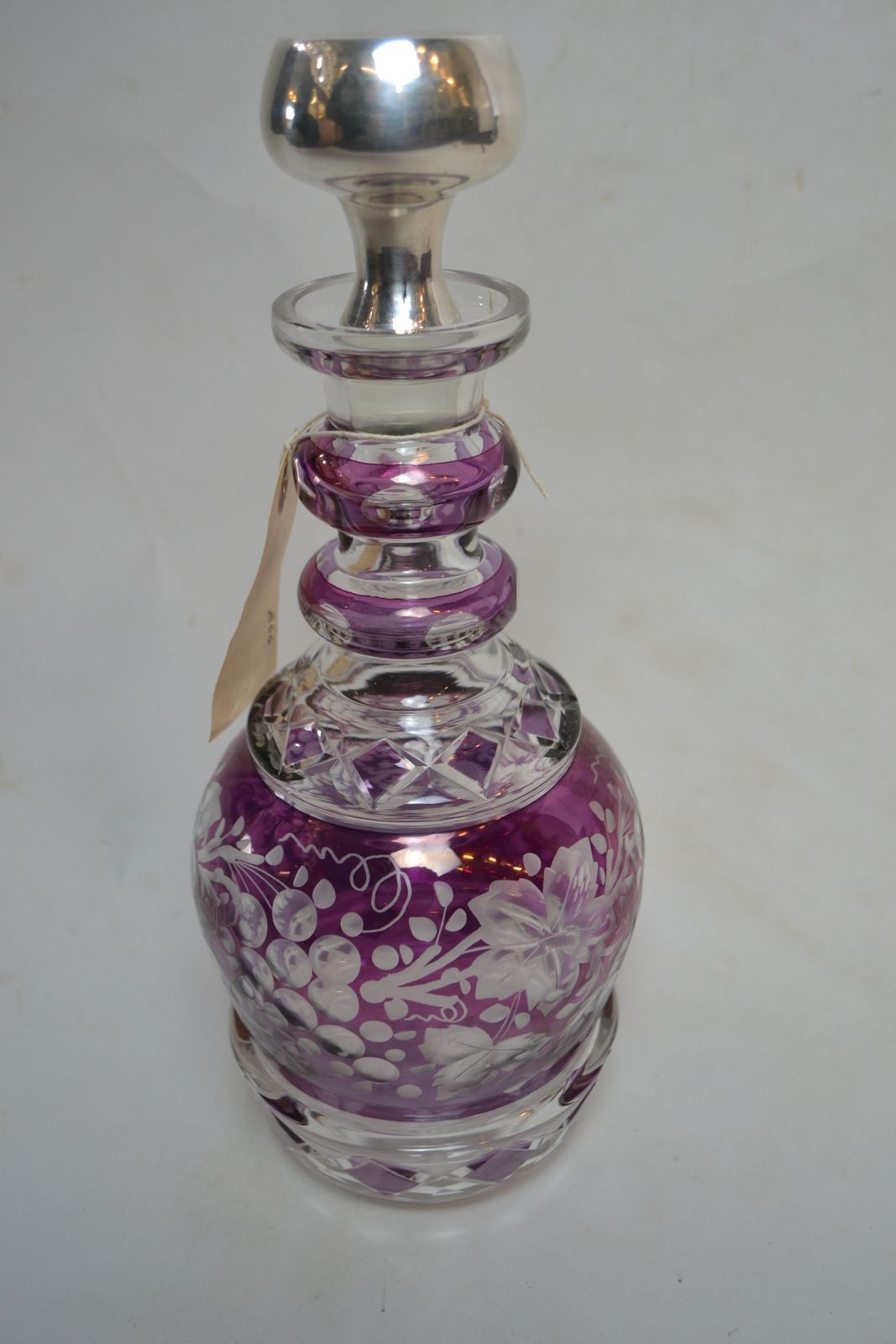 Discover our exquisite Continental silver and Bohemian glass decanter. 34cms high with a stunning purple glass overlay. Shop now for this unique find!