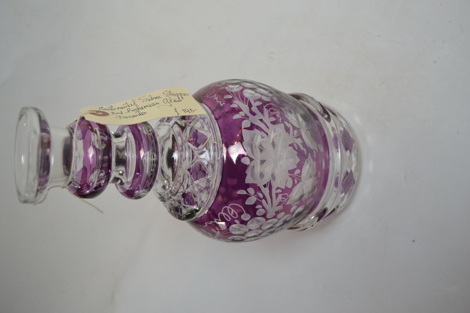 Discover our exquisite Continental silver and Bohemian glass decanter. 34cms high with a stunning purple glass overlay. Shop now for this unique find!