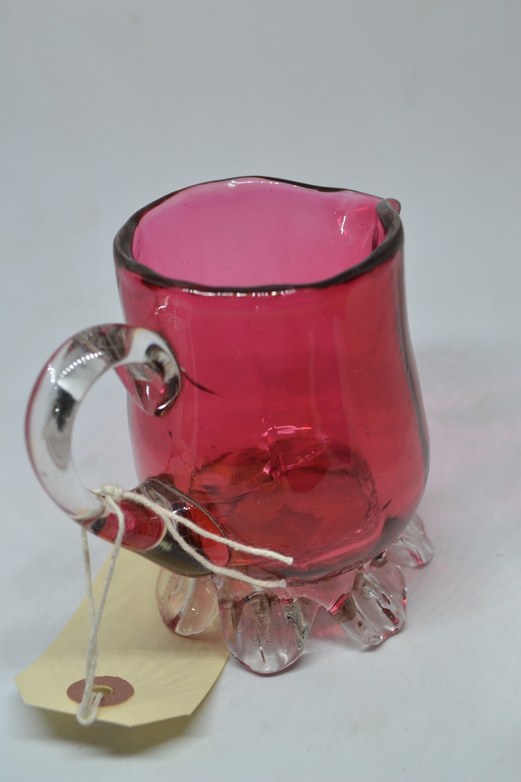 Discover our unique 1860 cranberry milk jug! Add a touch of vintage charm to your decor with this one-of-a-kind antique. Shop now and delve into history!