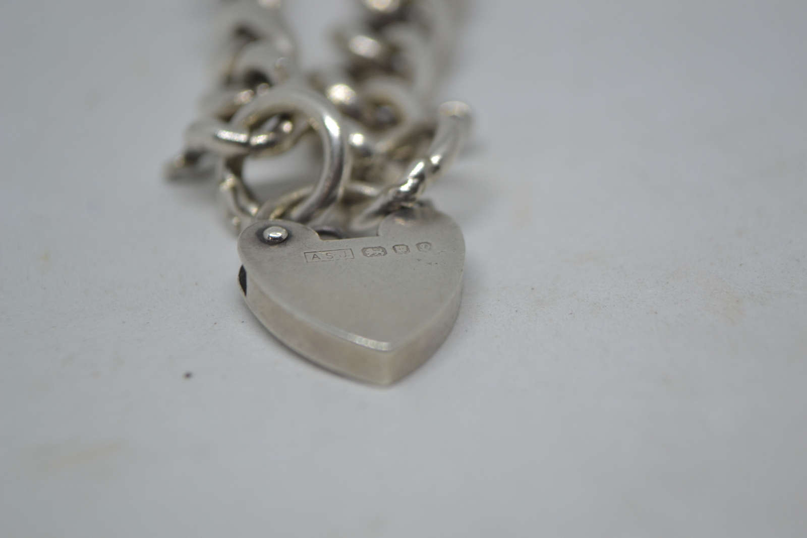 A Solid Sterling Silver Curb Link Bracelet  With Heart Padlock