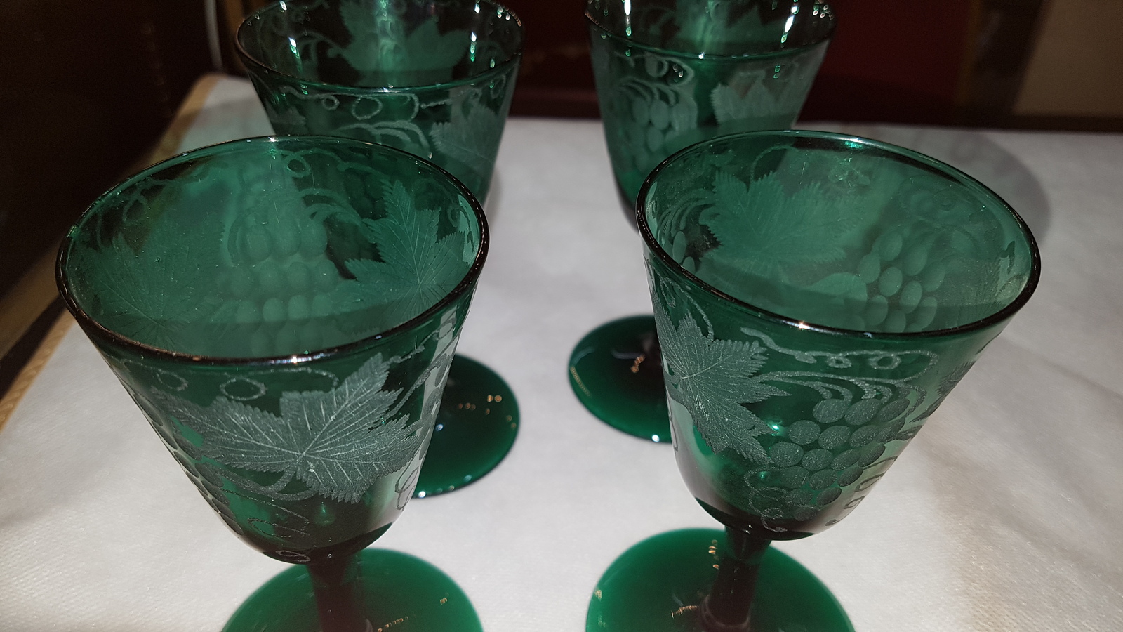 Discover our collection of 19th-century handblown Bristol green wine glasses. Engraved with unique vine leaves design and standing 13 cm high. Shop now for these one-of-a-kind pieces!