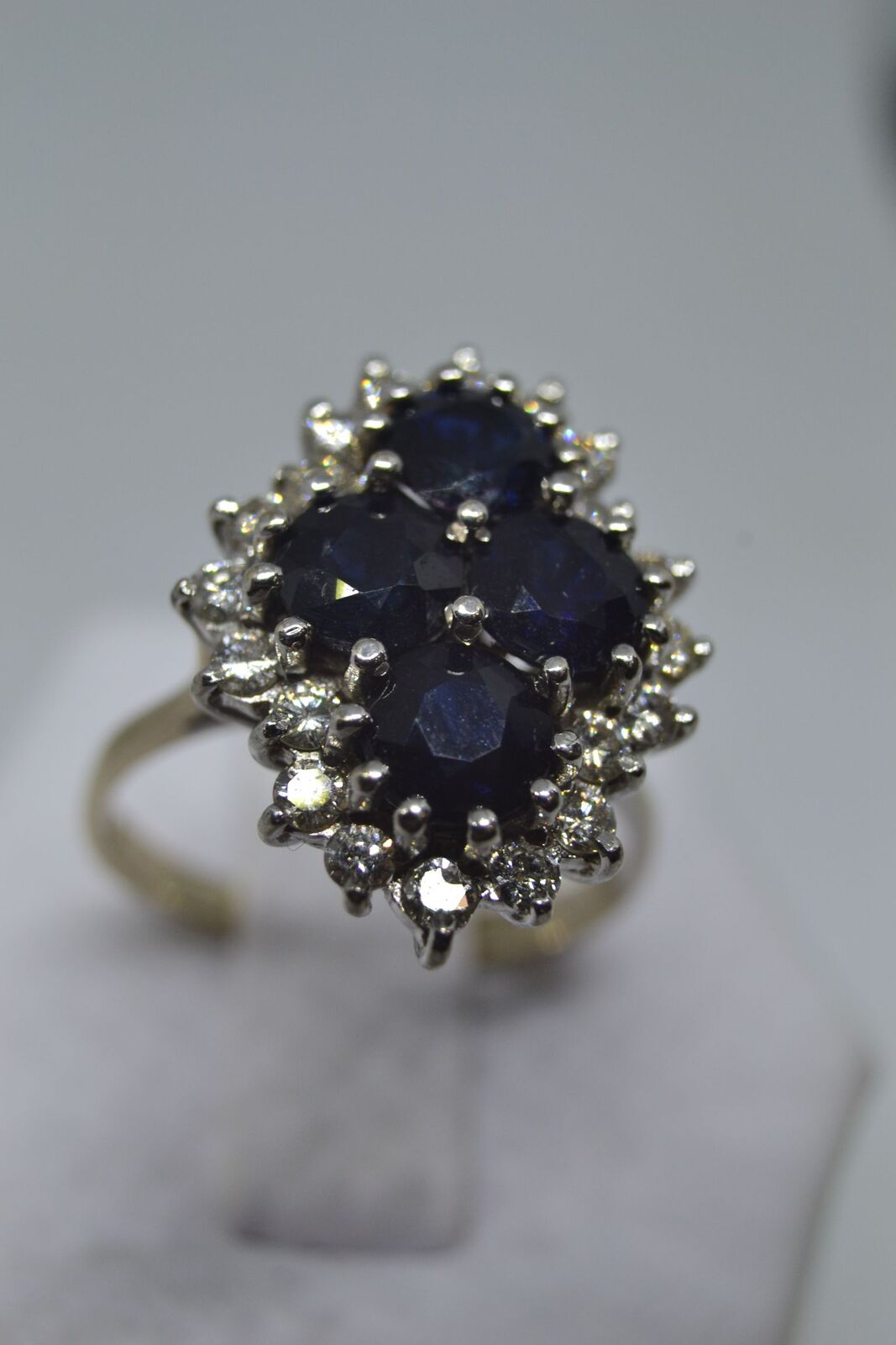 An 18ct white gold sapphire and diamond cluster ring