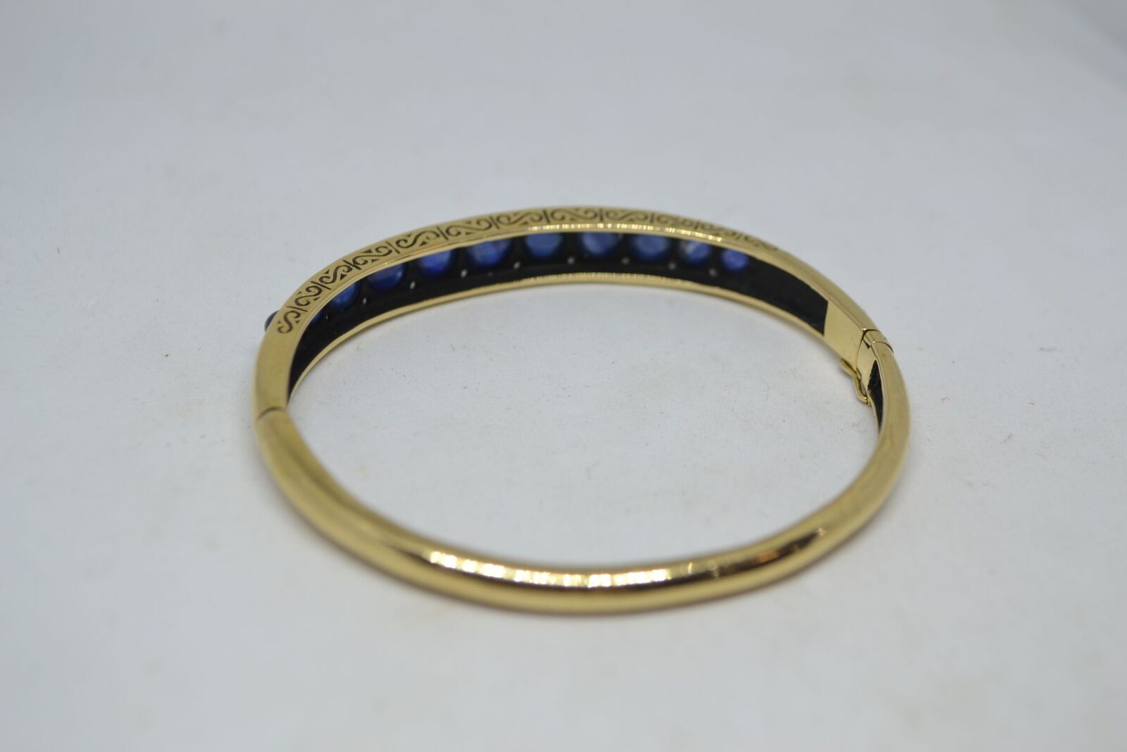 Shop our exquisite 9ct yellow gold sapphire bangle, accented with 11 sapphires, weighs 16g. See more details and order yours today!