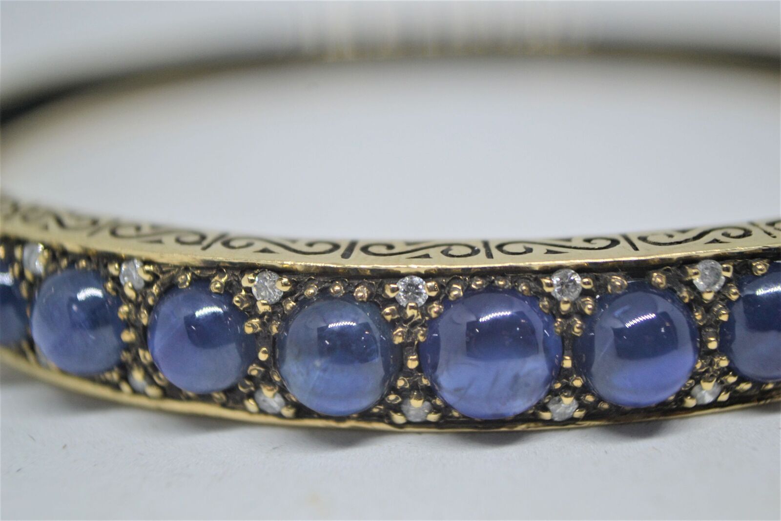 Shop our exquisite 9ct yellow gold sapphire bangle, accented with 11 sapphires, weighs 16g. See more details and order yours today!