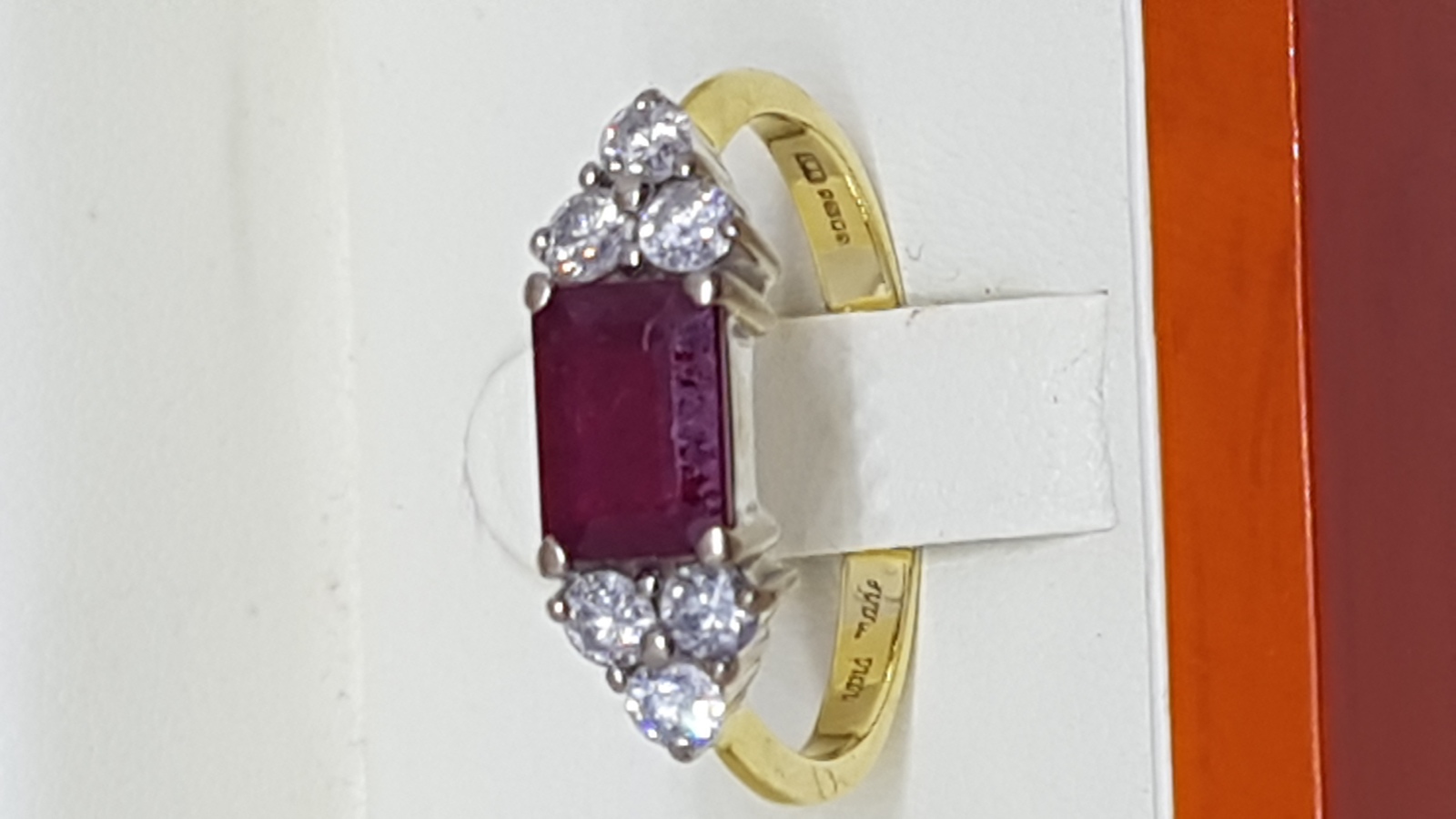 An 18 ct Yellow Gold Ring Set With Single Emerald Cut Ruby And Diamonds