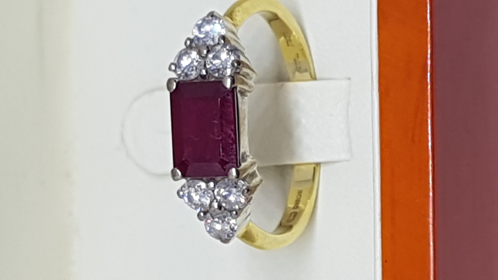 An 18 ct Yellow Gold Ring Set With Single Emerald Cut Ruby And Diamonds