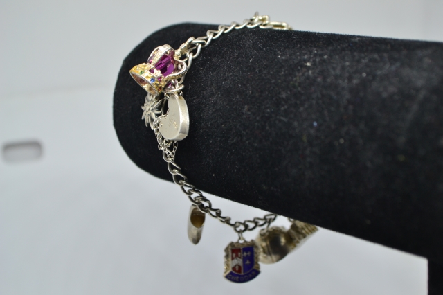 Discover our unique sterling silver charm bracelet, minted in Birmingham 1973 by RP. Weighing 23.7g and featuring nine delightful charms. Shop now!
